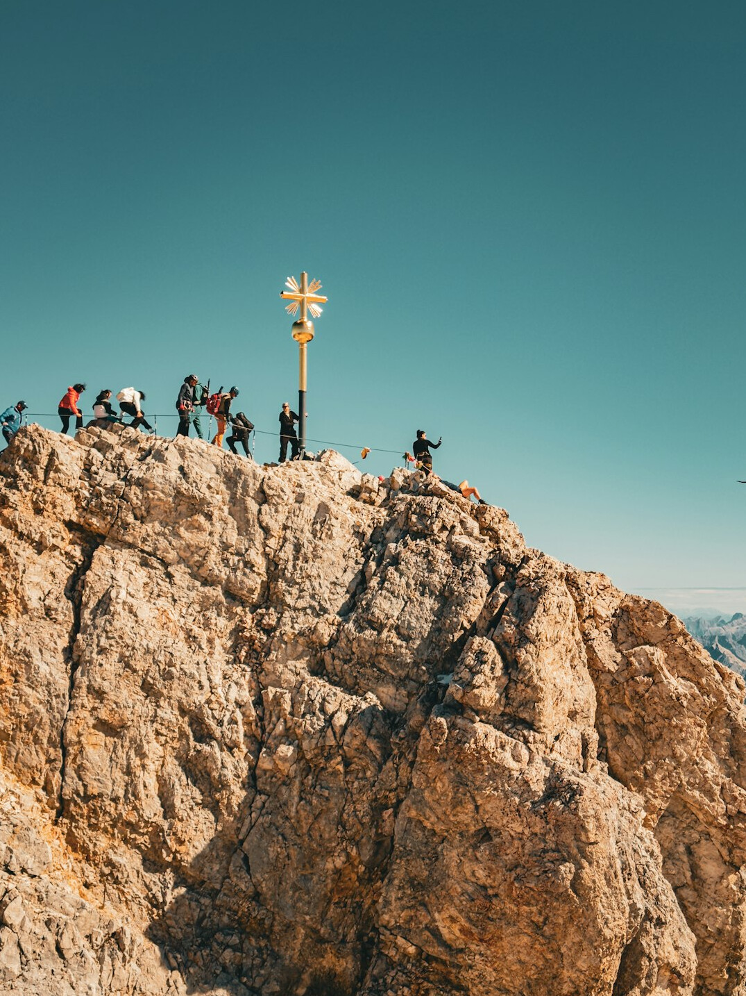 person climbing mountain peak