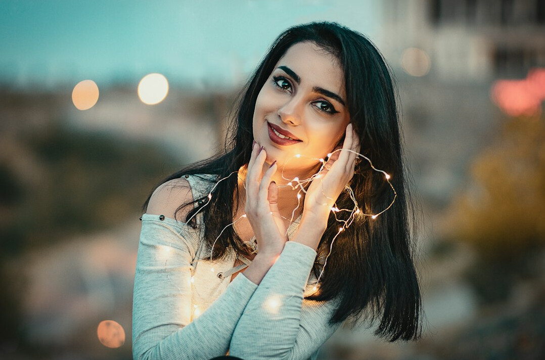 Smiling woman with long dark hair in a light top