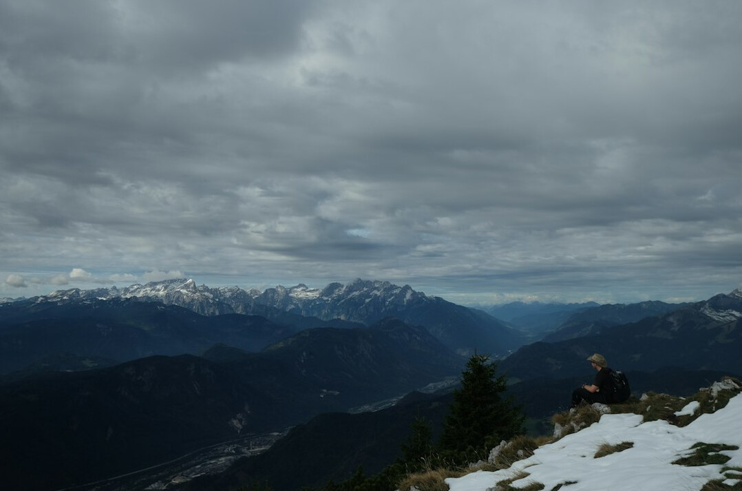 person climbing mountain peak